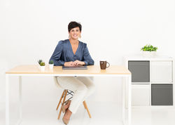 woman sitting behind desk headshot and branding posing
