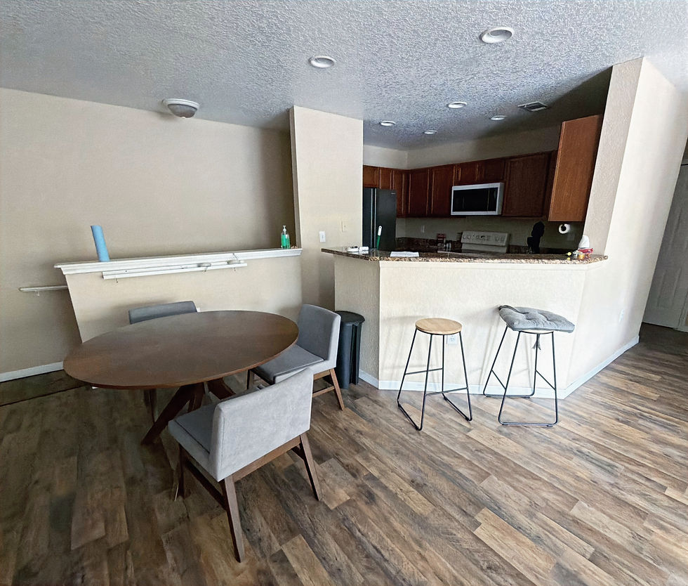 Living and dining area with breakfast bar and kitchen in furnished pilot housing in Palm Coast, Florida