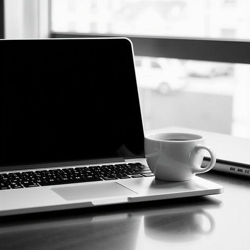 business consulting and strategy monochrome image of laptop and coffee.jpg