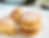 Small, golden-brown, fluffy, light pancakes dusted with powdered sugar, stacked on a white plate.