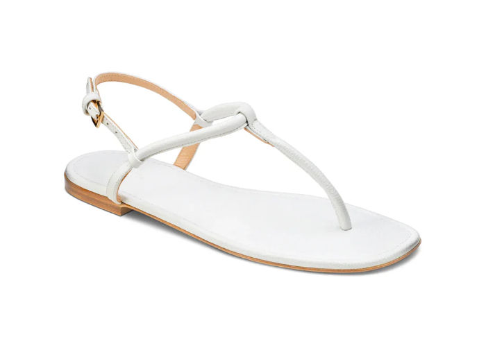 White flat thong sandal with ankle strap on a plain white background