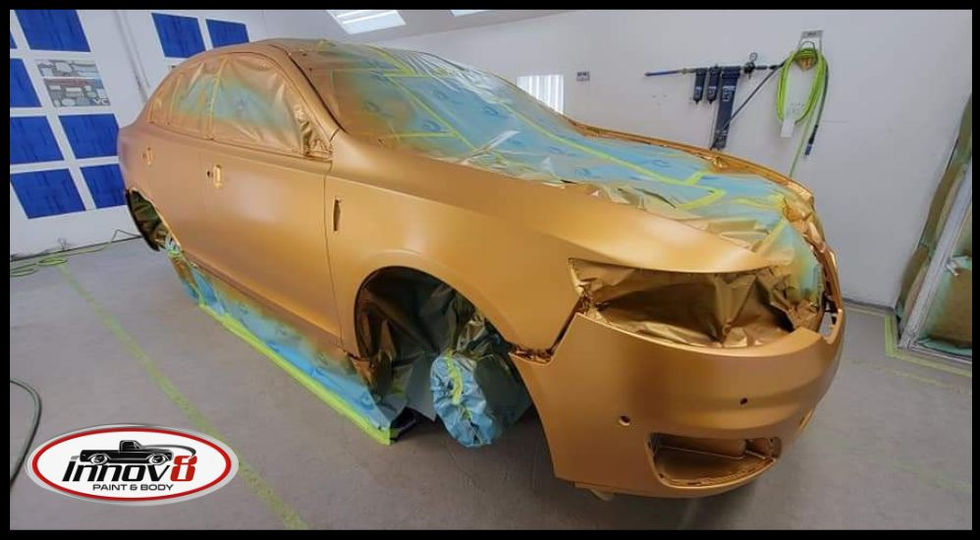 Custom gold base coat application for a high-end vehicle restoration at the Innov8 facility in Pueblo West.