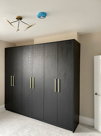 Bespoke floor-to-ceiling fitted wardrobes for a residential bedroom, custom-built by DJF Kitchens and Bedrooms