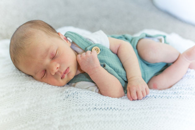 Newborn curled up sleeping