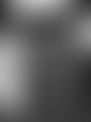 Film photo of a bride and groom holding hands with outstretched arms as they walk on a lawn. The photo is slightly blurry with movement as the couple smiles. The groom has his tuxedo jacket over his shoulder and the bride has her bouquet down by her side. 