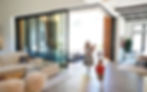 Wood-clad postless corner multi panel patio doors at Martis Camp Lake Tahoe residence with six-panel L-shaped configuration