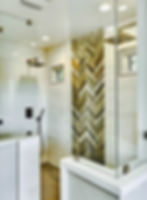 Dramatic chevron pattern tiled shower with multi color wood tone accent wall Bay Area renovation