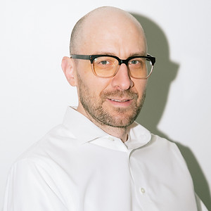 Team member from Greylyn Wayne photographed in a modern, professional portrait