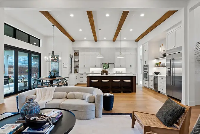 Living room in the “Ohana” home at the 2021 Street of Dreams, designed by Greylyn Wayne with warm tones, modern furnishings,