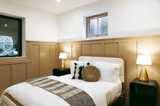Serene bedroom in the 2024 “Vista” home at Street of Dreams, staged by Greylyn Wayne with luxurious bedding and calming, mode