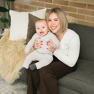Jody Wallace’s daughter Jess holding her baby, reflecting the family roots behind Greylyn Wayne’s design studio