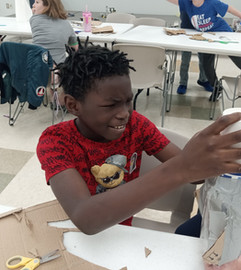 Young boy concentrating on a craft project
