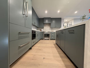Sage gray custom kitchen cabinets with integrated appliance panels in Danville, CA