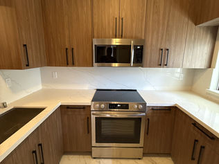 Walnut U-shaped custom kitchen cabinets with white quartz countertops in the Bay Area