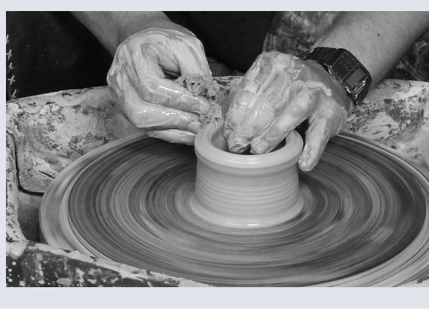 Peter Valenti throwing a cylinder in grayscale