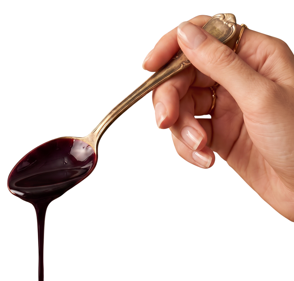 Spoonful of rich Defender botanical tonic ready to enjoy