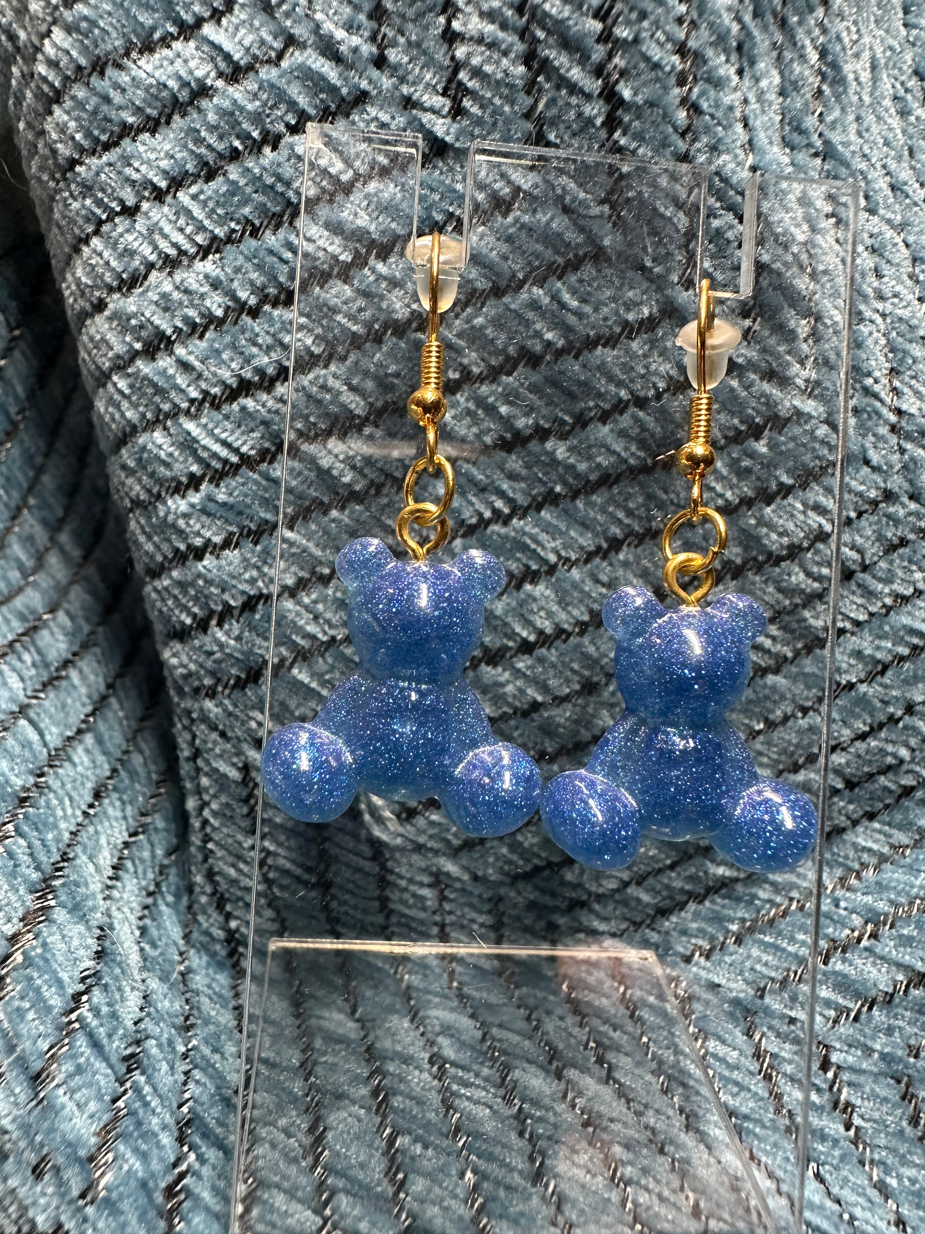 Sparkling blue glitter teddy bear dangle earrings, handcrafted with a high-shine resin finish.