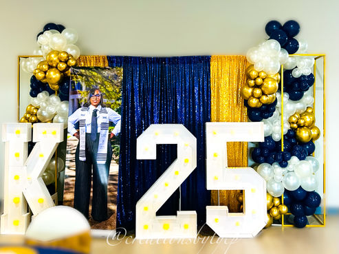 navy blue pearl white and gold balloon garlands along with gold and blue sequin panels and 6ft gold rectangle frames and Marquee letter K and Marquee number 25