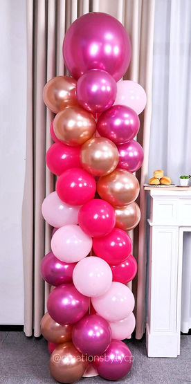balloon column in spiral pattern with hot pink, metallic pink, light pink and rose gold balloons