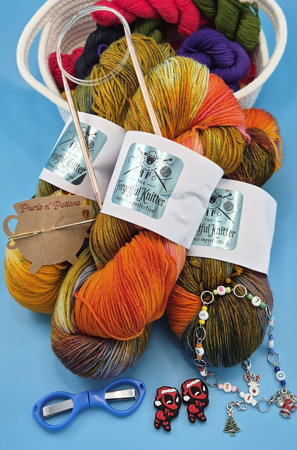 3 skeins yarn sherbet punch color, knitting row counter, stitch markers, circular copper knitting needles, scissors kit