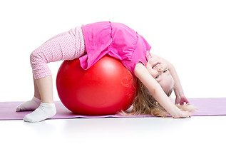 Cute Kid Girl Stretching On Pilates Ball.jpg