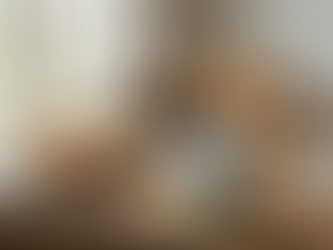 Table with a pie, brownies, cake, and a can of Sweet Cow condensed creamer, near a window. Checkered napkins add a cozy touch.