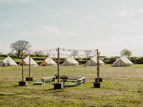Bell tent village and campfire for glamping hen party