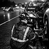 close up black and white image of tow truck operator wearing helmet from the back (not sho