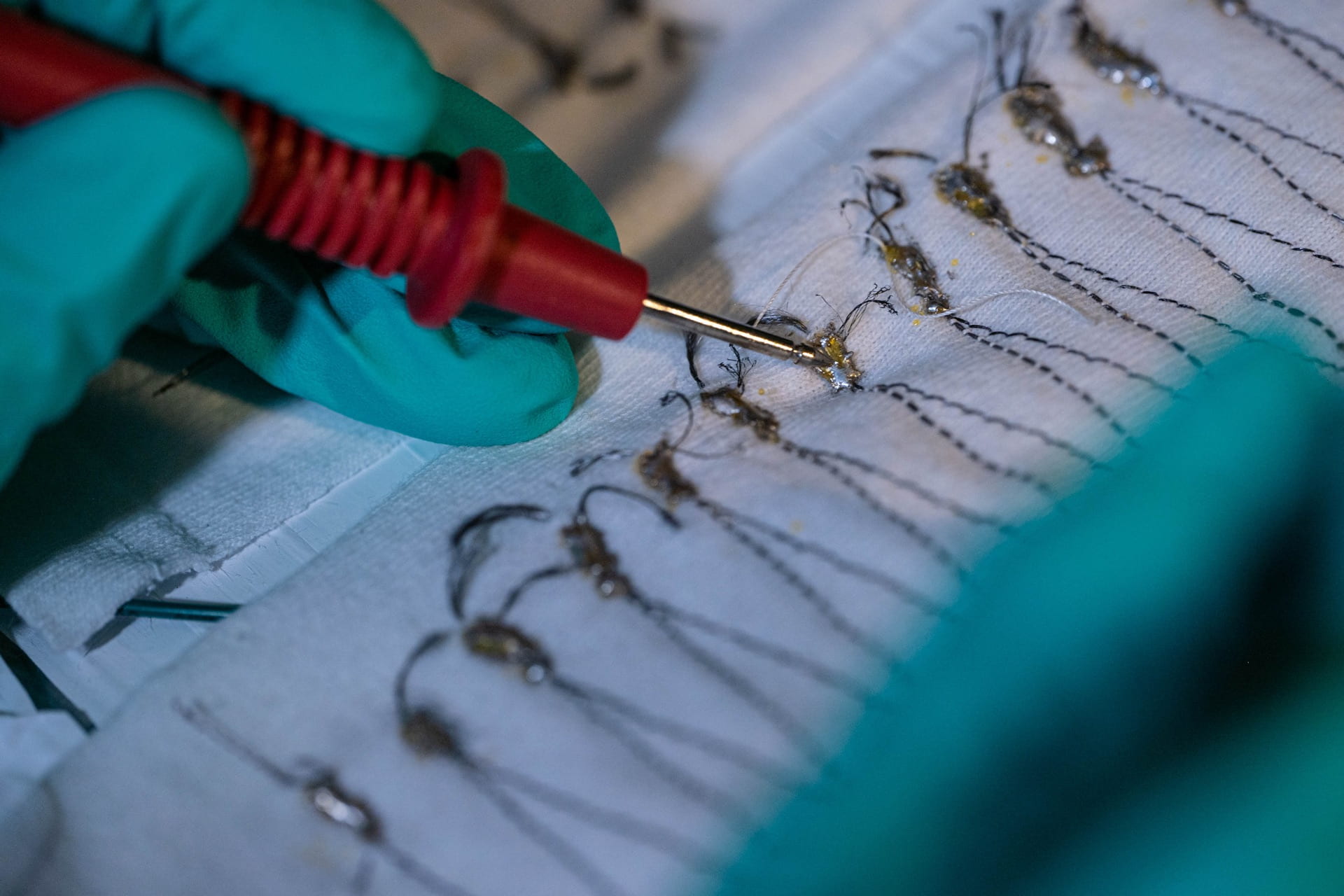 Carbon nanotubes woven into thread-like fibers and sewn into fabrics become a thermoelectric generator that can turn heat from the sun or other sources into energy. @ Jeff Fitlow