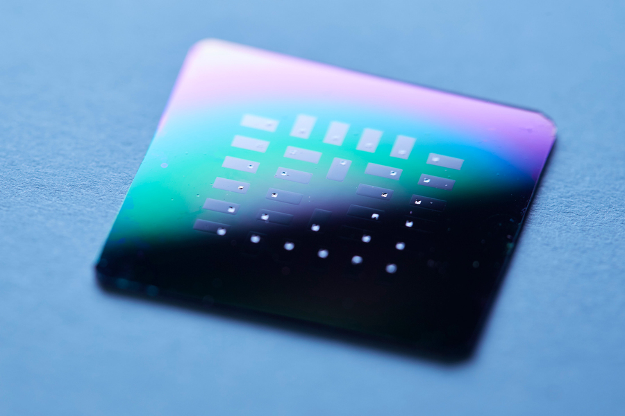 Silicon chip with 30 individual glucose micro fuel cells, seen as small silver squares inside each gray rectangle. @ Kent Dayton