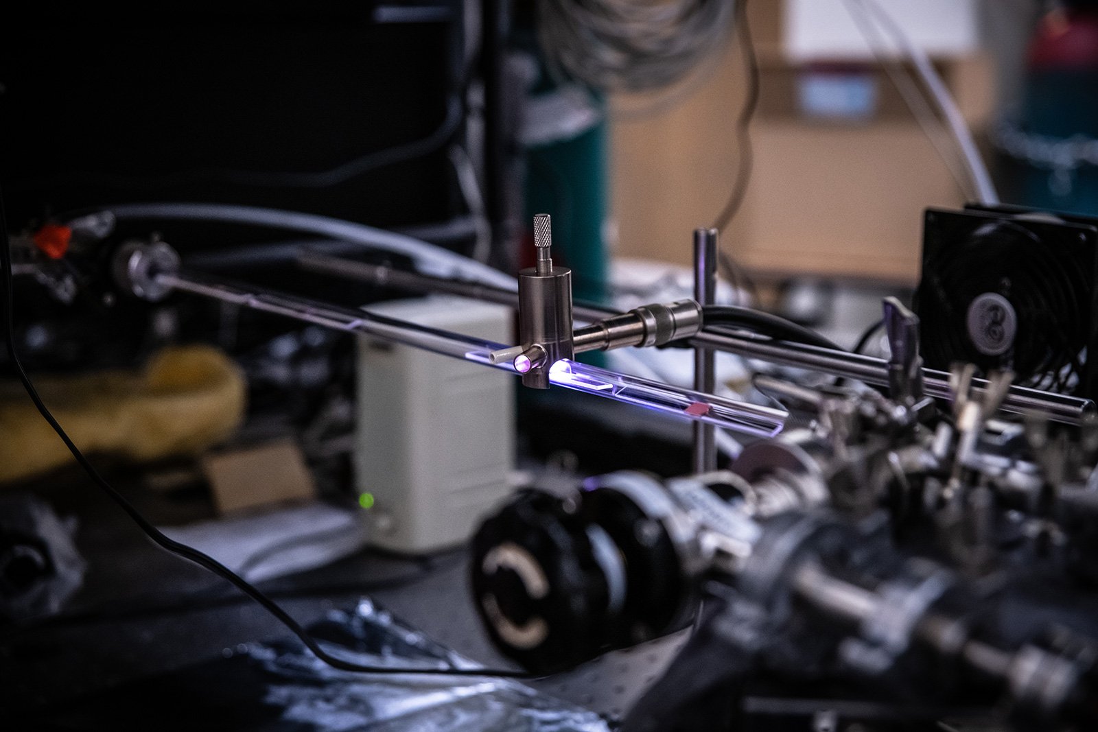 A ray of plasma, which glows pink, is used to activate a gas of hydrogen and methane molecules and break them down into smaller fragments. The sample to be coated, such as a two-dimensional copper line, is then immersed in the plasma, and carbon from the gas gets deposited onto the surface as thin sheets of graphene. @ Caltech