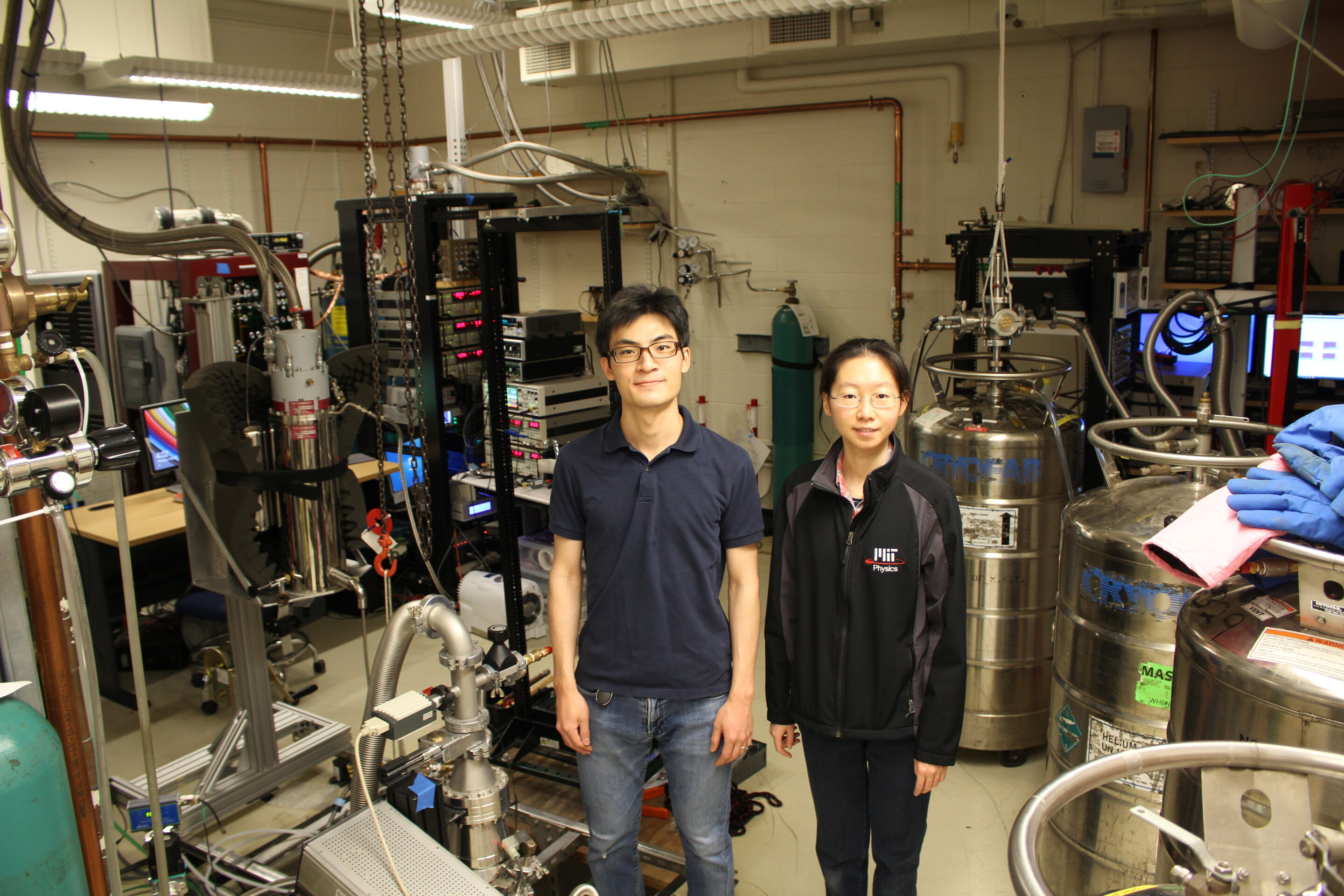 MIT researchers and colleagues report the creation of a new ultrathin material with ferroelectricity, a property that could give the material important applications in computer memory and more. Here Kenji Yasuda (left), an MIT postdoctoral fellow, and Xirui Wang, an MIT graduate student in physics, stand in the MIT lab key to the work. @ Kenji Yasuda and Xirui Wang