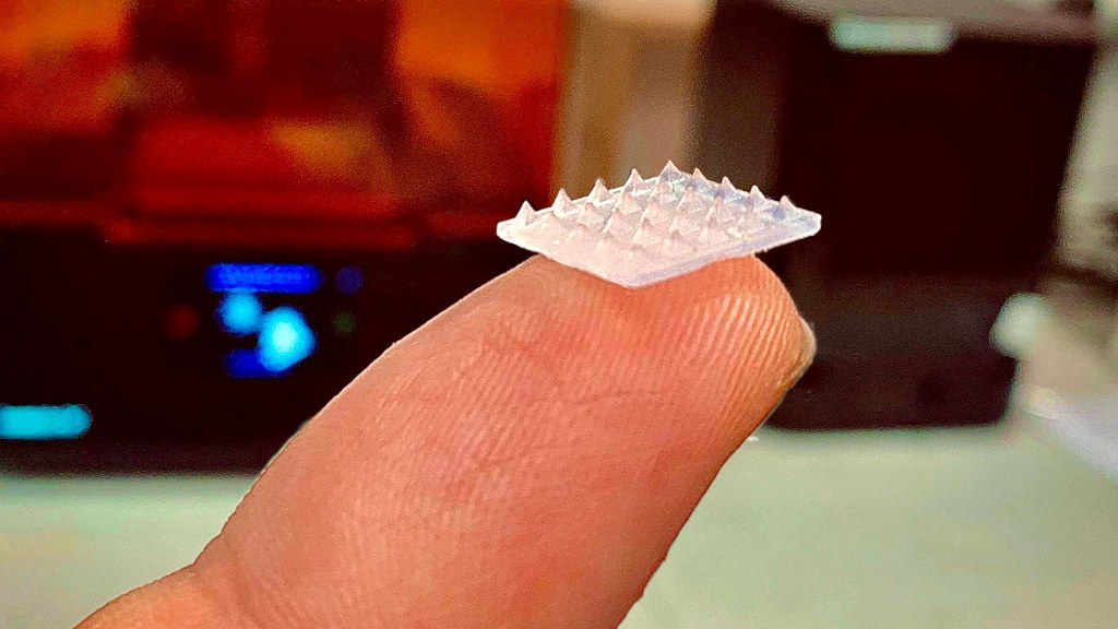 The patch is smaller than a pound coin and is covered in barely visible microneedles. @ University of Bath