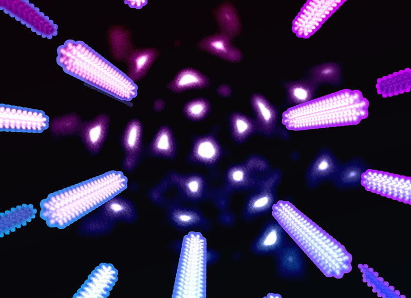 Patterned electron probes yield an extra level of precision in measuring tungsten diselenide lattice parameters. The complex-shaped electron probe is depicted in the background, and exaggerated changes in experimentally observed diffraction peaks due to temperature-induced lattice expansion are depicted in the foreground. @ Los Alamos National Laboratory