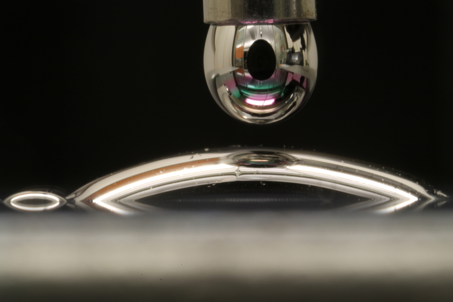 Researchers can now treat a surface so that a droplet of mercury spreads out on it, instead of beading up. @ Courtesy of the researchers