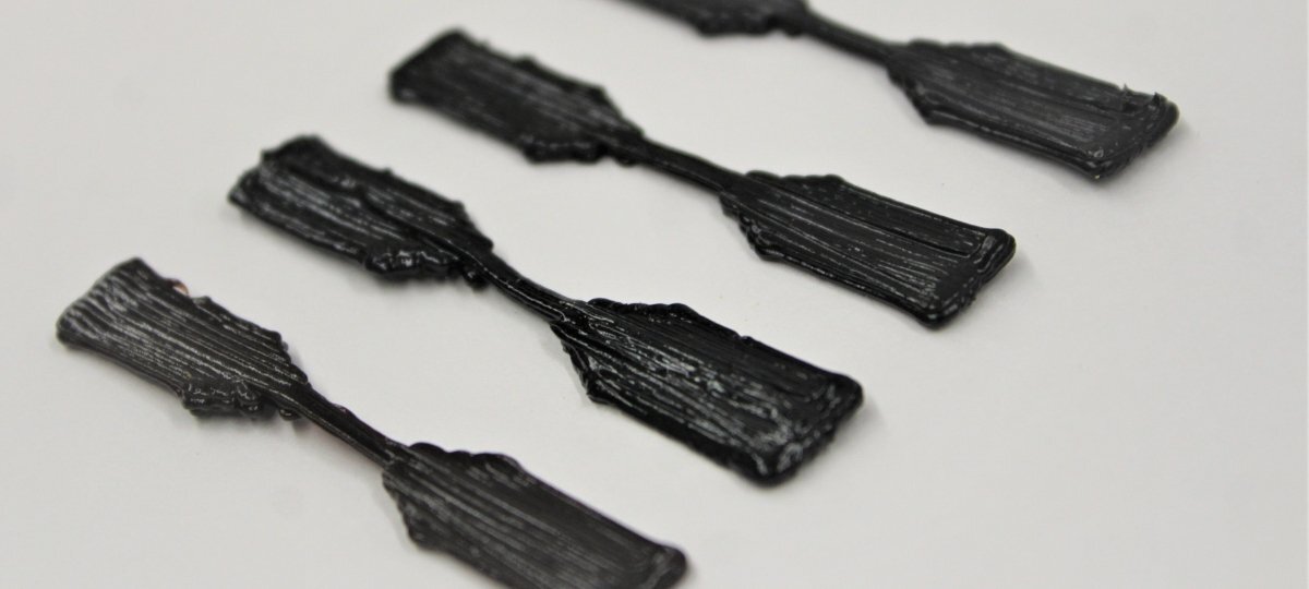 3D-printed dog-bone-shaped nano-composite specimens for tensile testing. @ Masoud Kasraie