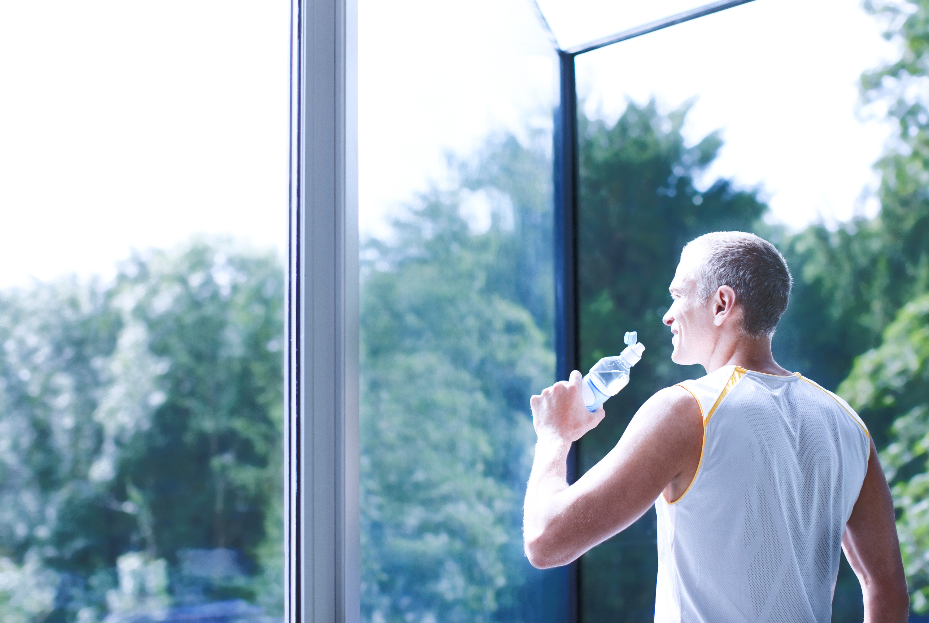 A man drinking water glad he uses HCG and TRT