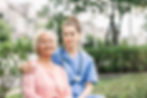 vecteezy_caregiver-embracing-senior-in-park_1223455.jpg