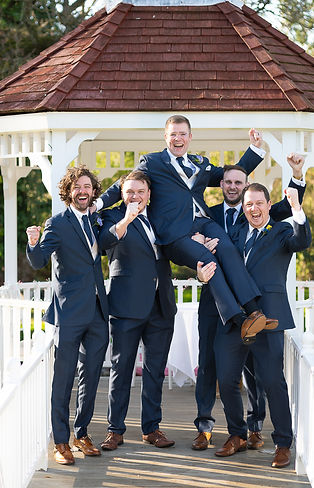Groomsmen carrying groom on shoulder and cheering. Sheene Mill wedding venue. .JPG