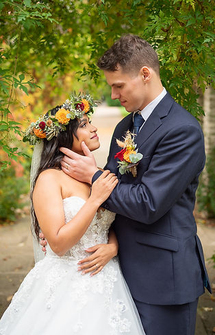Groom gently caressing brides face in a beautiful intimate portrait..JPG