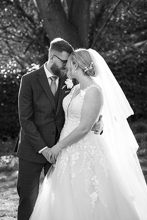 Bride and groom in a tight embrace.JPG