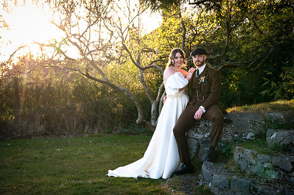 Bride and groom posing for a portrait with a nice sunset as a backdrop..JPG