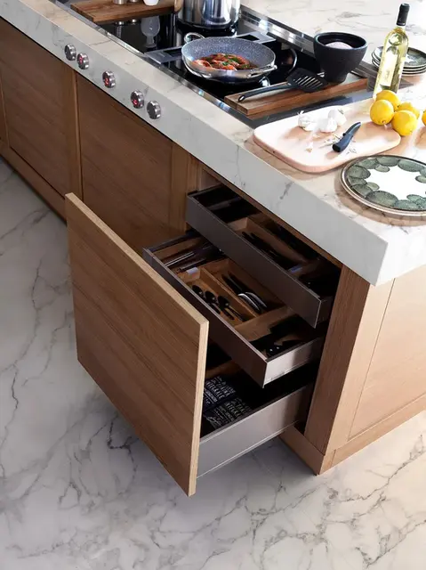 Detalj otvorenih fioka kuhinjskog ostrva Effeti Wood sa premium organizacijom pribora i drvenom završnom obradom.