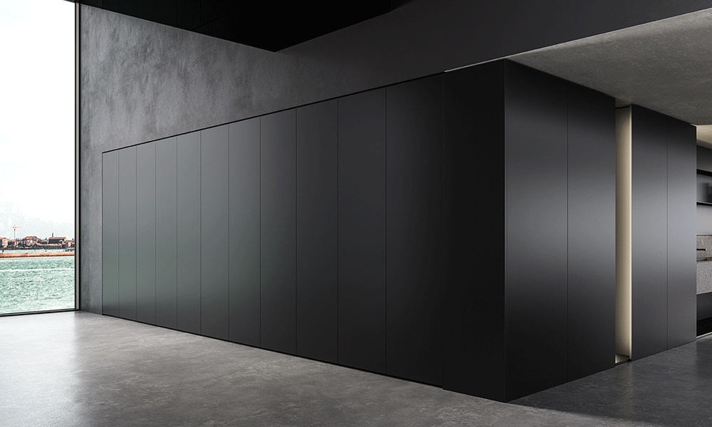 Minimalist luxury kitchen with concealed black cabinetry, matte finishes, and handleless contemporary design.