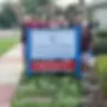 Group of people stands by a sign that reads Loaves & Fishes, Thank You!
