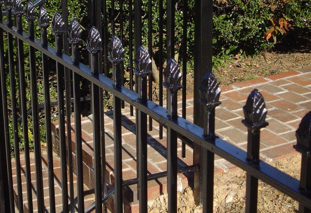 Black residential fence with decorative finials