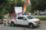 Kinship's Pride parade float: truck with rainbow flags and riders