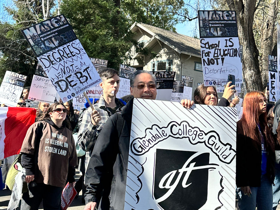 Protesters with signs "Solano College Faculty Guild" and "DEGREES BUT STILL IN DEBT".