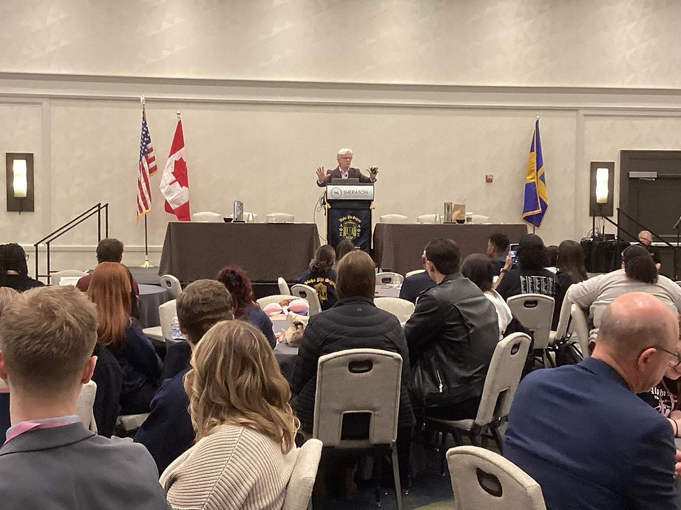 Speaker addressing a large audience at a conference