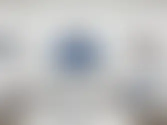 Cell phone store employee cleaning checkout counter and wiping demo phones to meet retail store cleaning standards